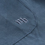 NB embroidery on blue shirt