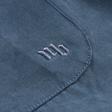 NB embroidery on blue shirt