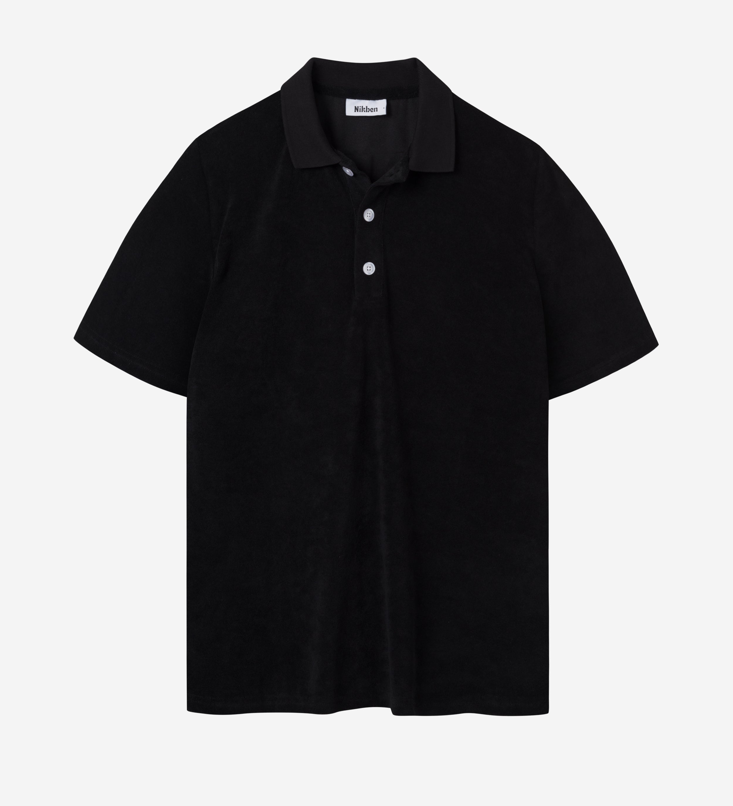Black short sleeve piké shirt in terry toweling fabric.