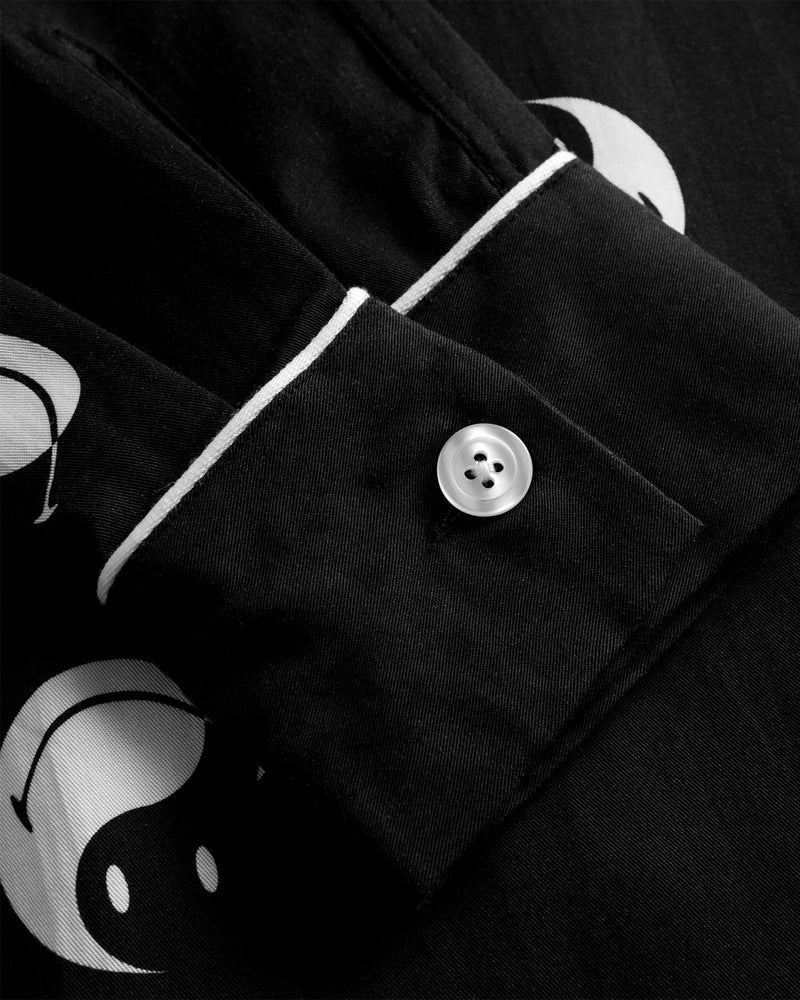 Sleeve with pearl button on black shirt with white smiley print