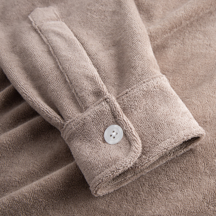 Beige shirt sleeve with white button