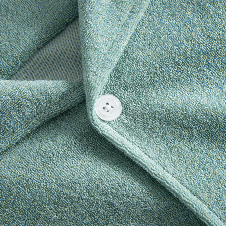 White button on green Terry toweling shirt