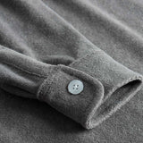 Grey shirt sleeve with white button