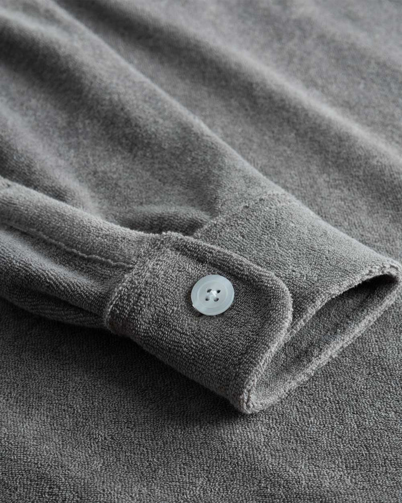Grey shirt sleeve with white button