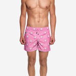 Model wearing pink printed swim trunks