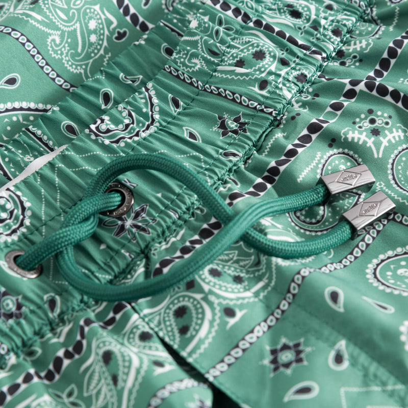Drawstring waistband on green swim trunks