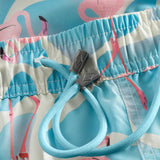 Drawstring on blue swim trunks with pink flamingo print
