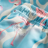Logo on blue swim trunks with flamingo print