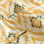 Zip back pocket on yellow printed swim trunks