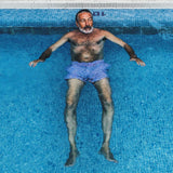 Man in pool wearing swim trunks