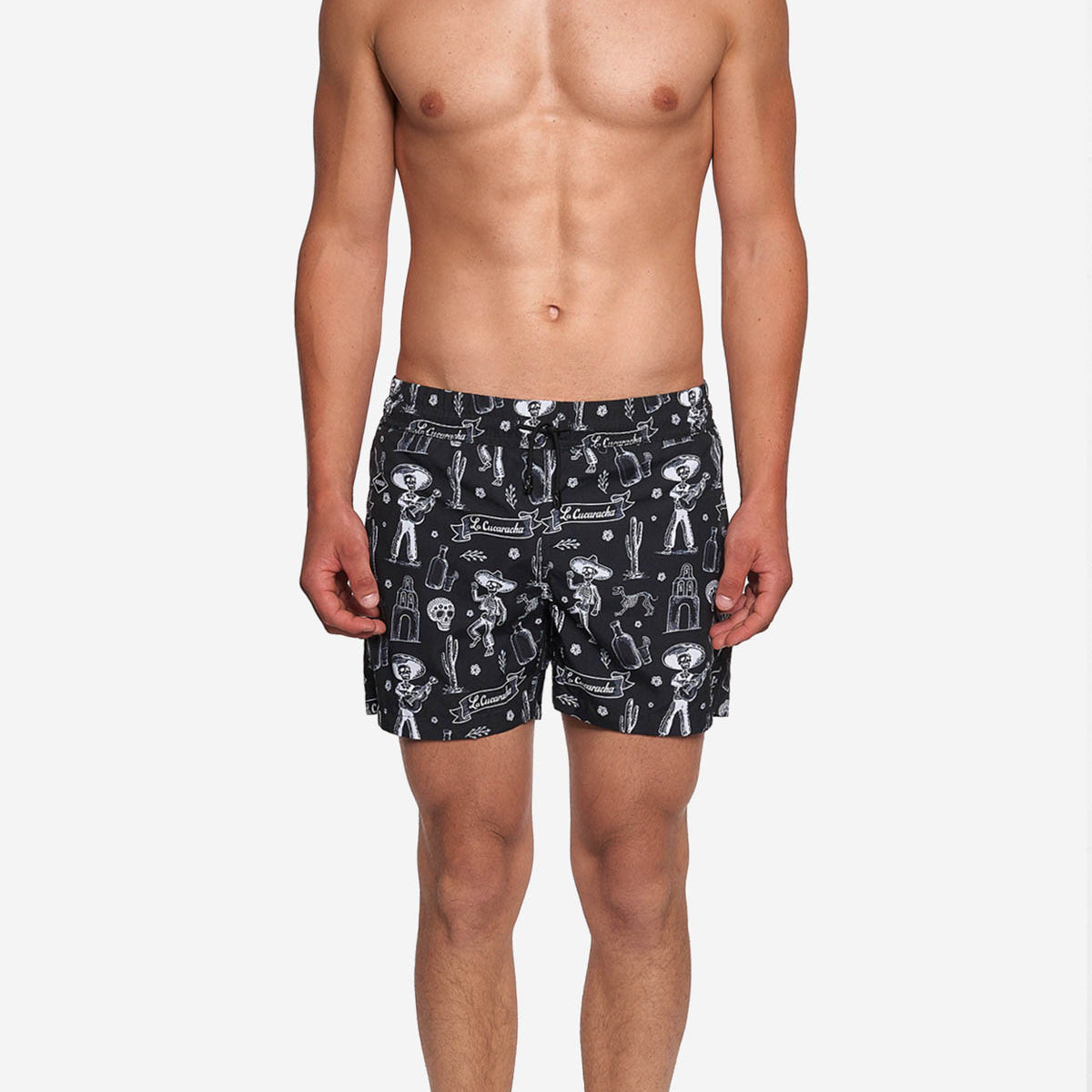 Model wearing black mid length swim trunks with white print