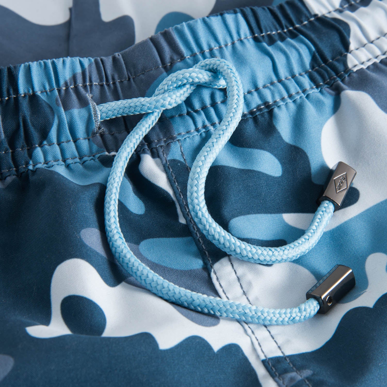 Drawstring waistband on blue camouflage  printed swim trunks