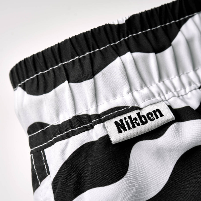 Logo on black/white swim trunks