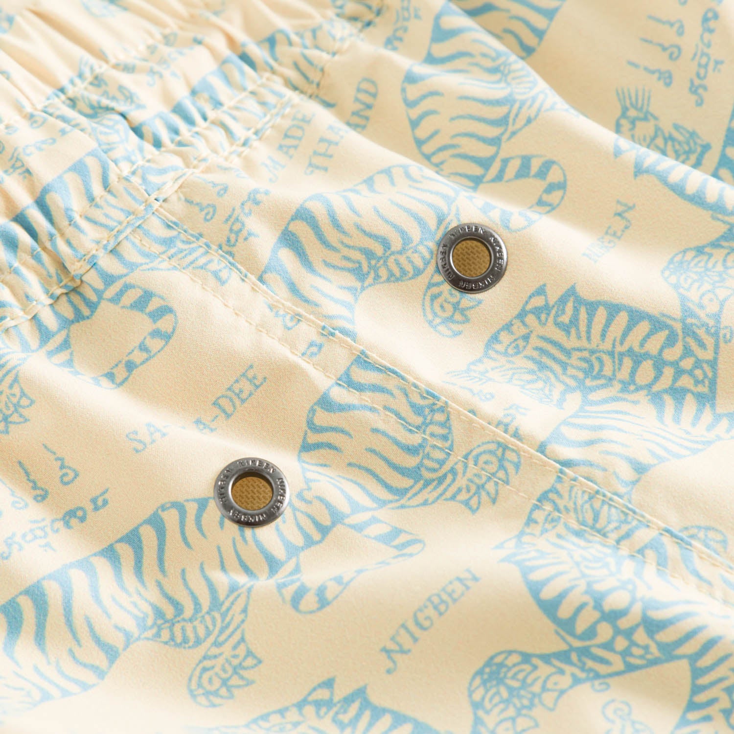 Close up of yellow swim trunks with green tiger print