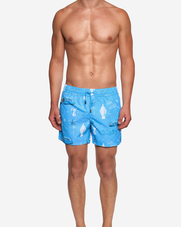 Model wearing blue mid length swim trunks with white print