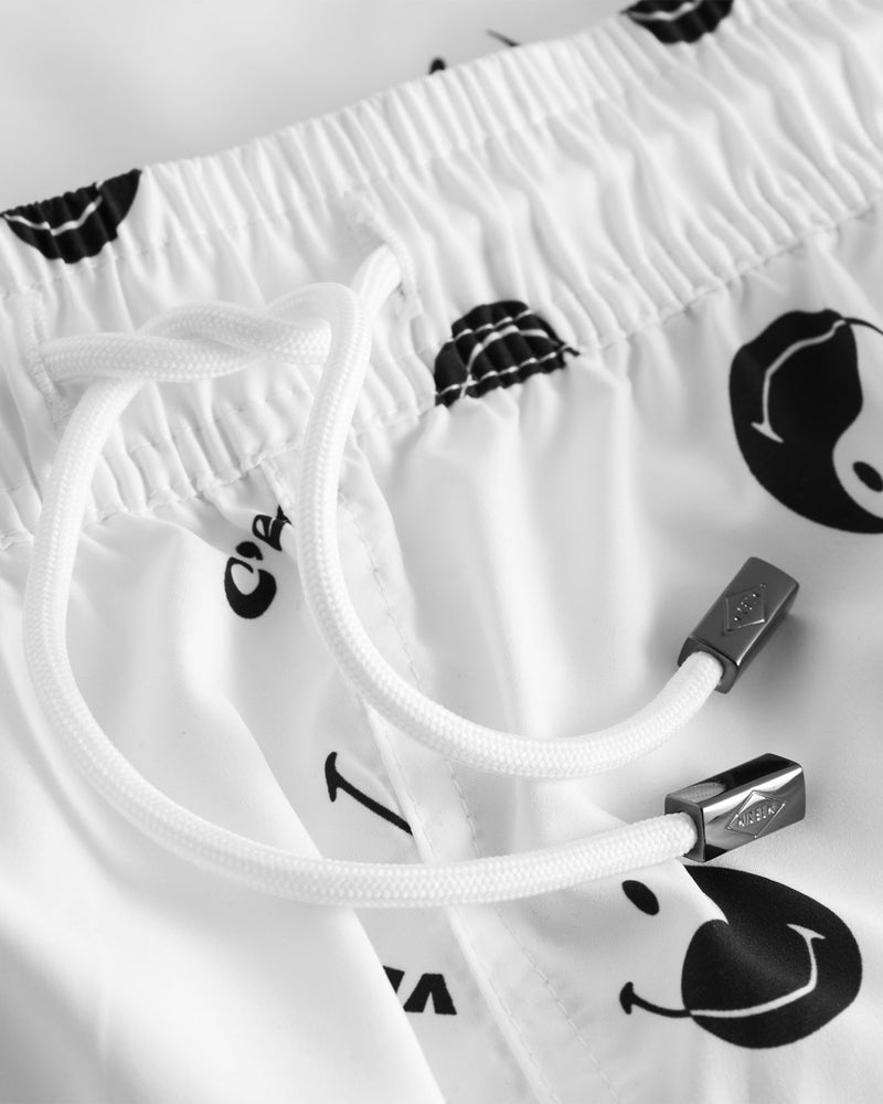 Drawstring on white swim trunks with black smiley print