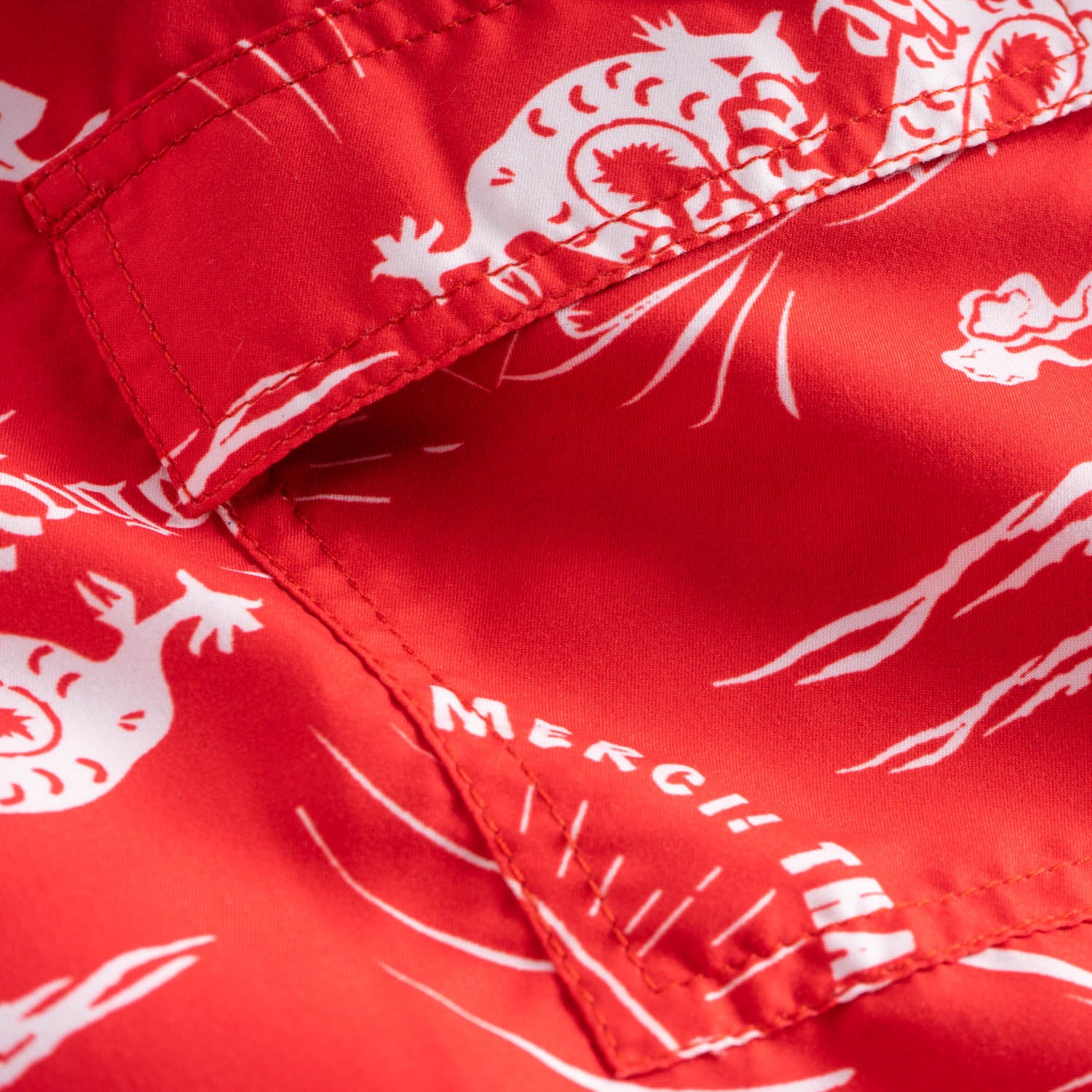 Back pocket on red swim trunks with white print