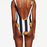 Model wearing black-white striped swimsuit with open back