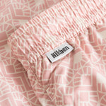 White label on pink swim trunks