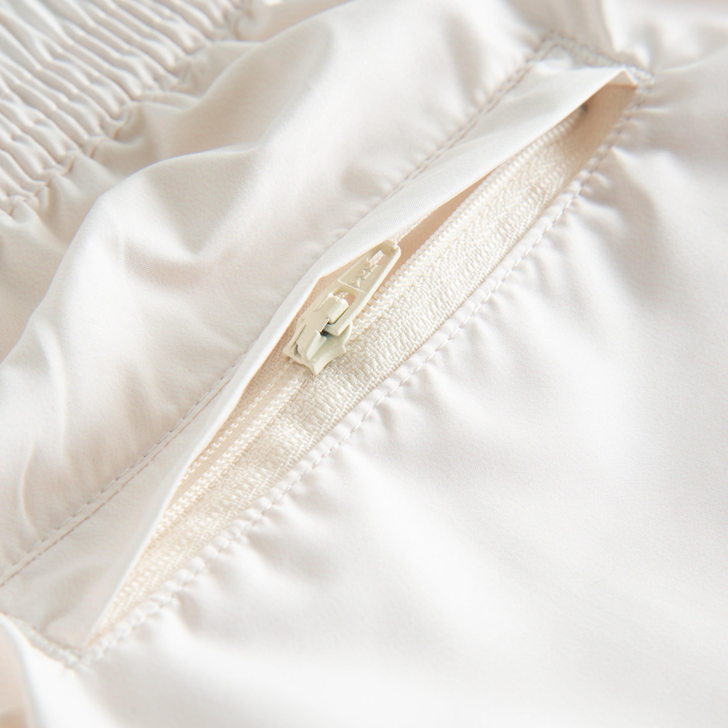 Back zipper pocket on cream white swimtrunks