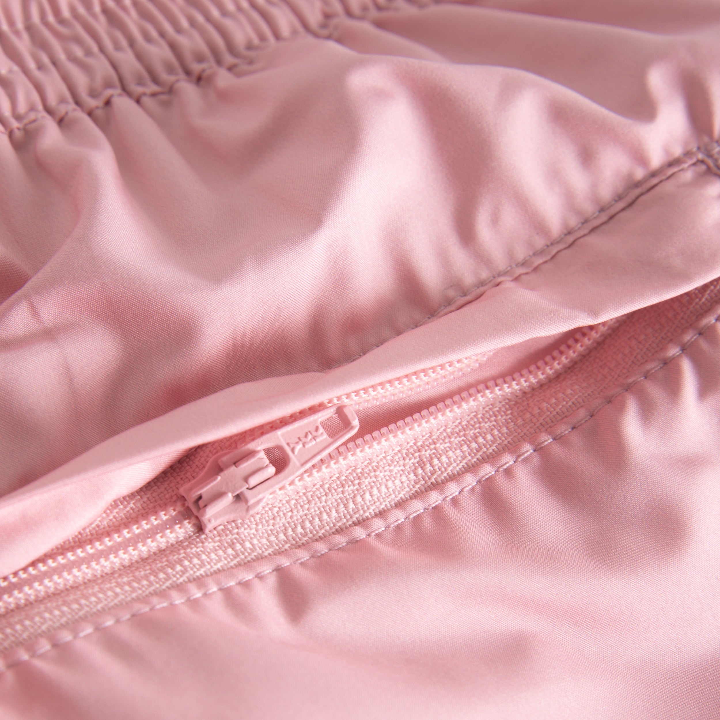 Back zipper pocket on plain pink swim trunks