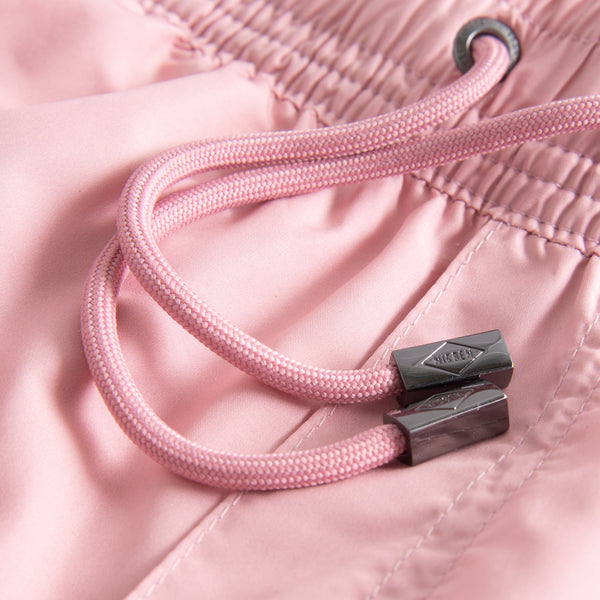 Drawstring on plain pink swim trunks