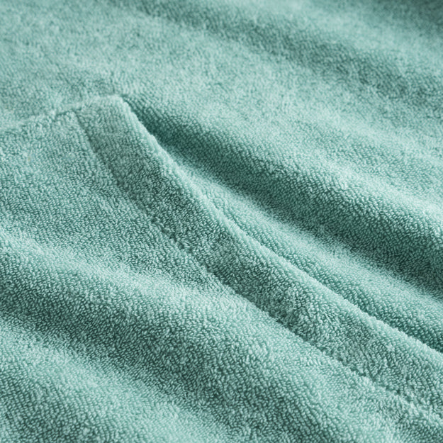 Close-up of stitchings on a green Terry toweling hoodie.