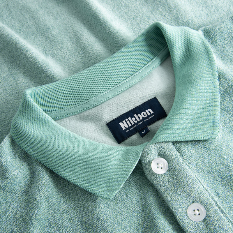 Collar and white buttons on green shirt in Terry toweling fabric
