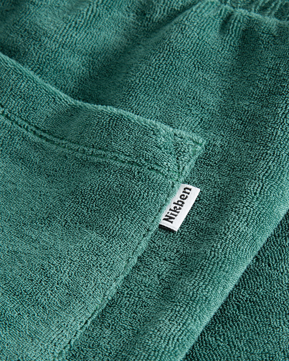 Label on green shorts in Terry toweling fabric