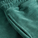 Side pocket of green shorts in Terry toweling fabric