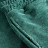 Side pocket of green shorts in Terry toweling fabric