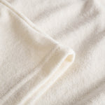 Close up of off white terry towelling fabric