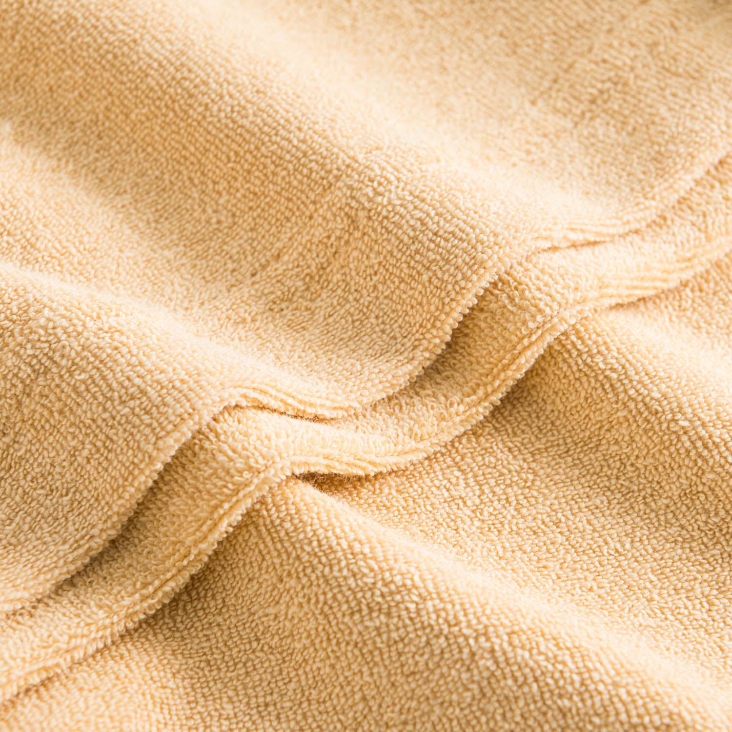 Close up of sand colored terry towelling fabric