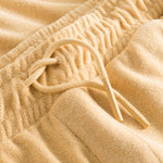 Drawstring waistband on sand colored terry towelling shorts