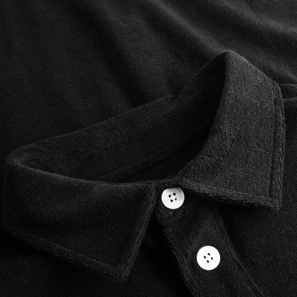Collar on black shirt with white buttons