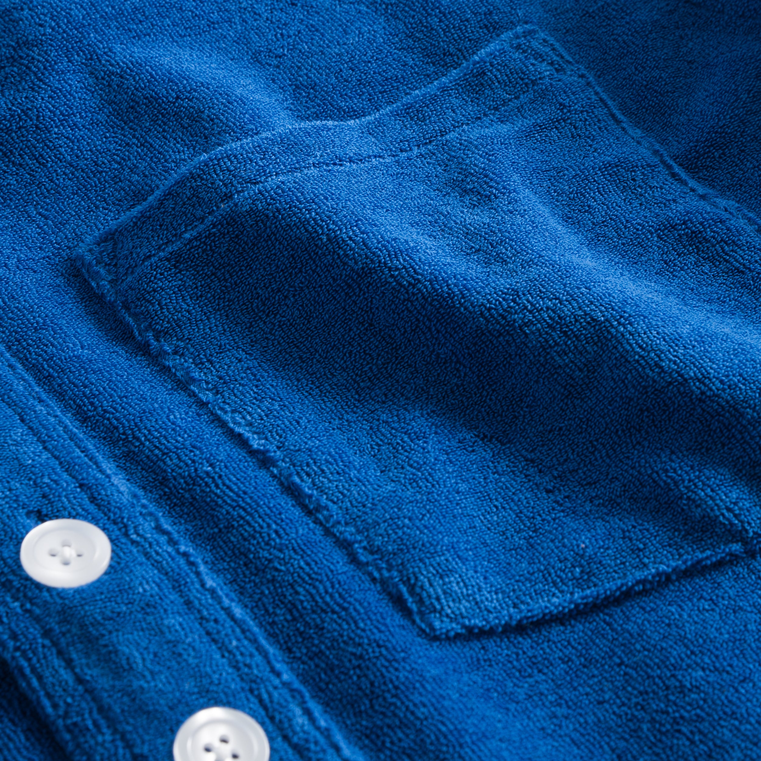 Chest pocket on indigo blue shirt in terry towelling fabric