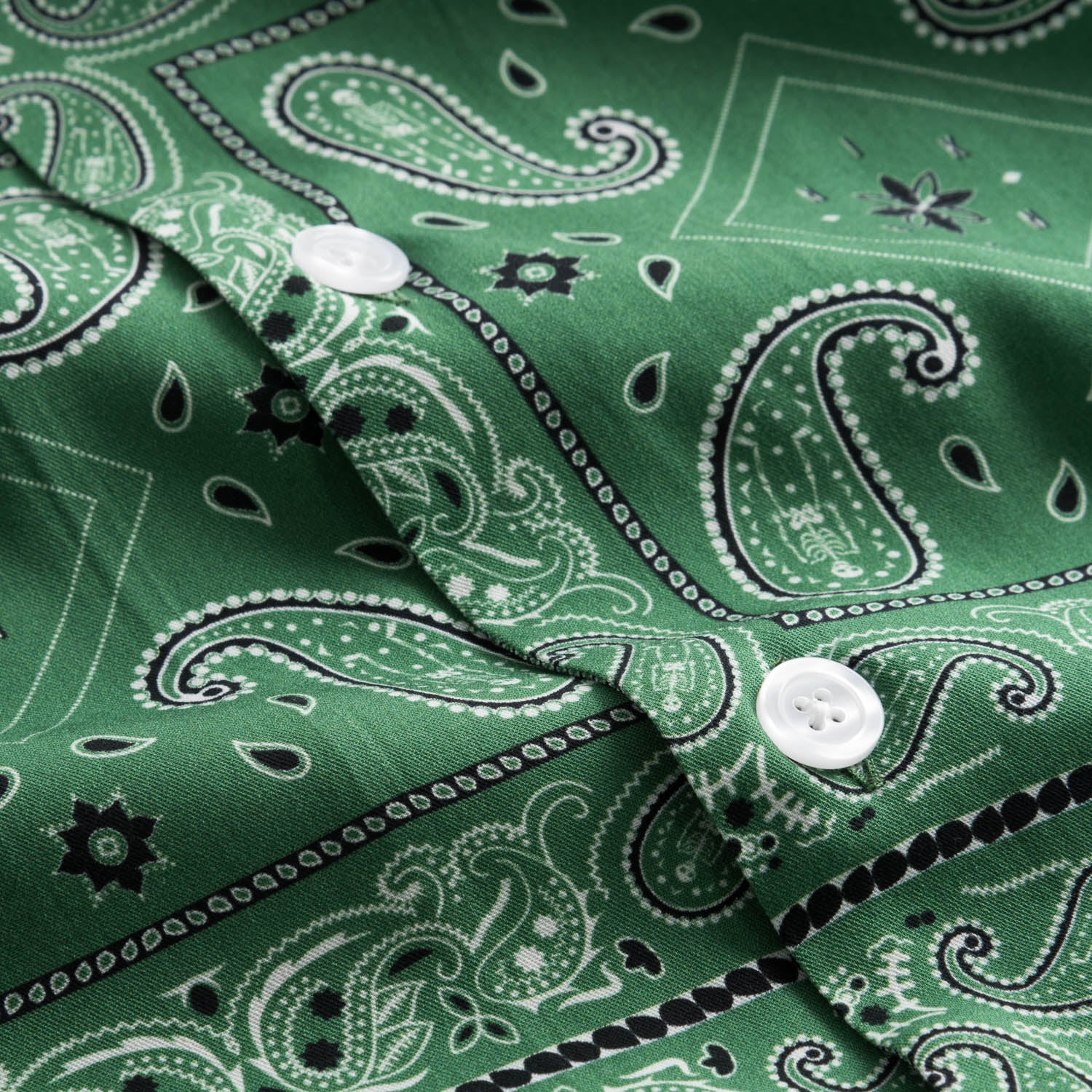 White pearl buttons on green vacation shirt