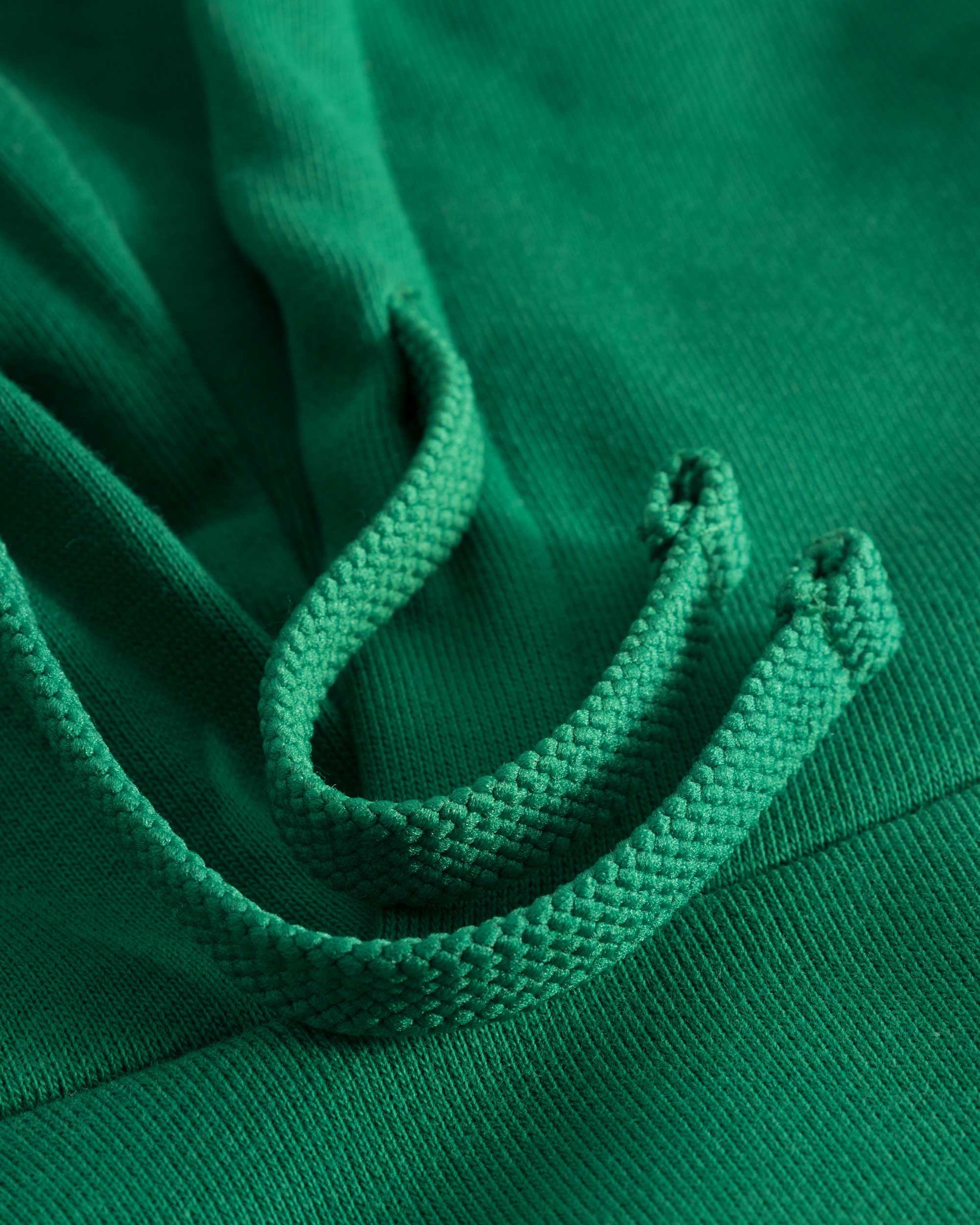 Green drawstrings on green hoodie