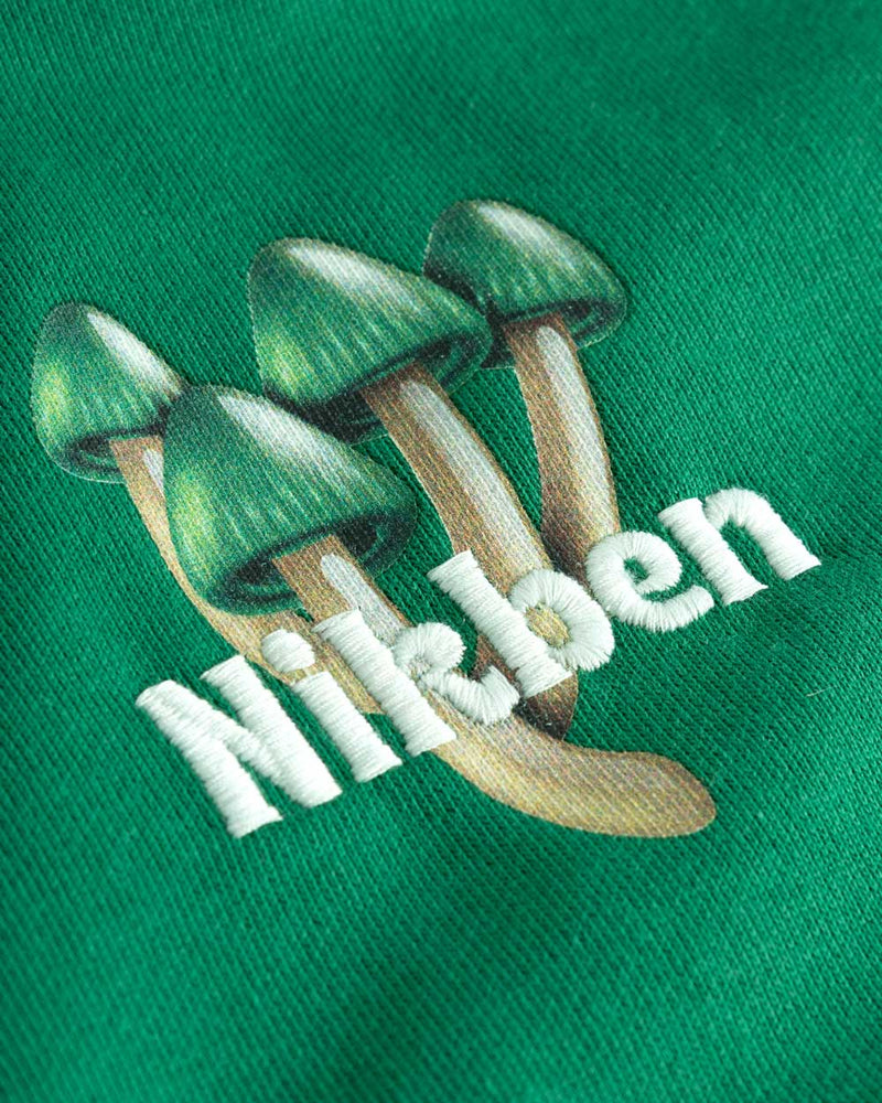 Green mushrooms and white text on green hoodie