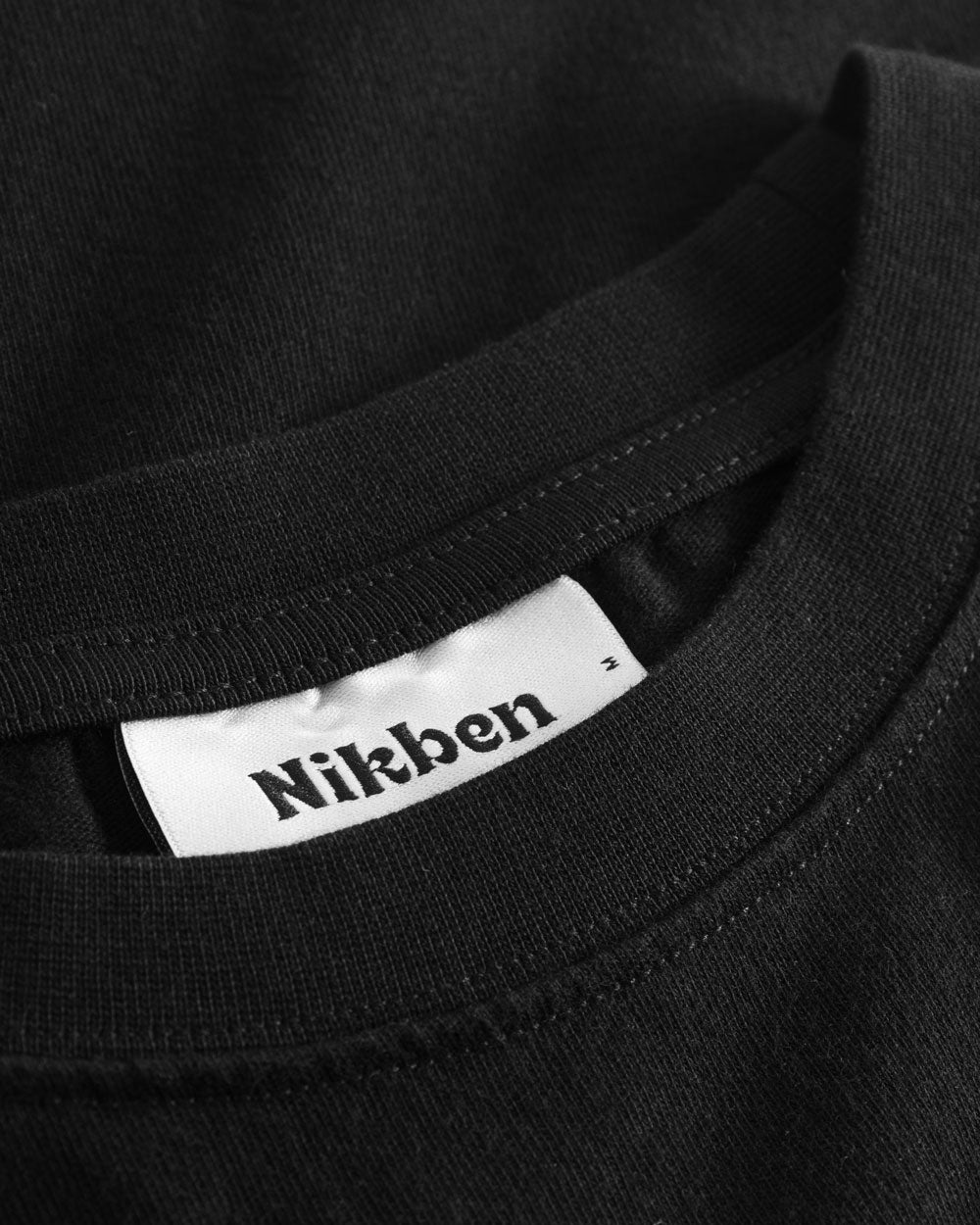 Nikben neck label on black t-shirt