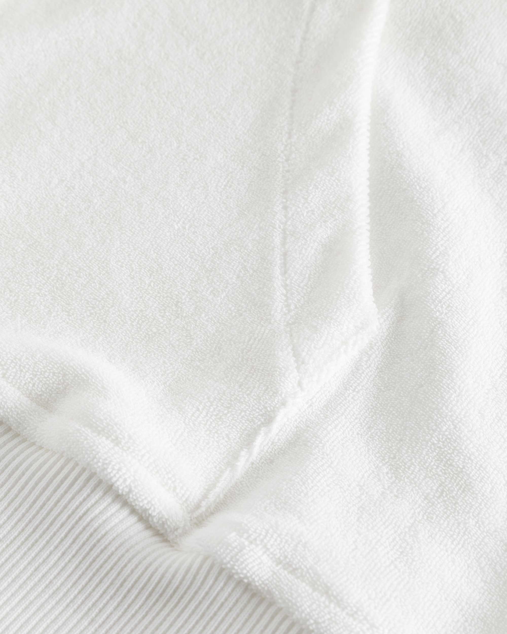Close up of stitchings on a white hoodie
