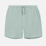 Mint green waffle-patterned mid-length shorts with two front pockets and a drawstring.
