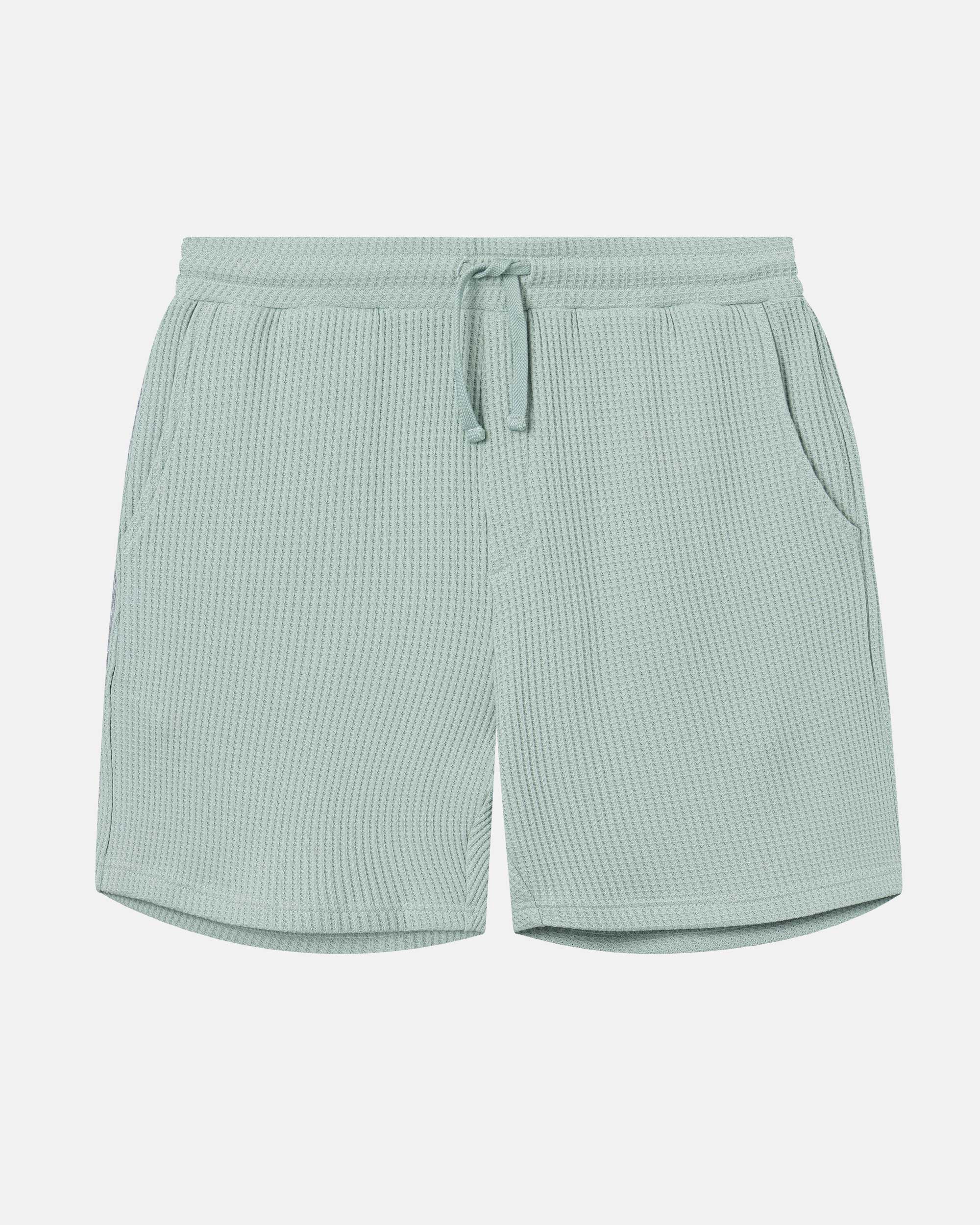 Mint green waffle-patterned mid-length shorts with two front pockets and a drawstring.