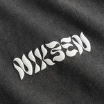 Close up of white text logo on washed black t-shirt