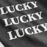 White "Lucky" text print on washed black t-shirt.