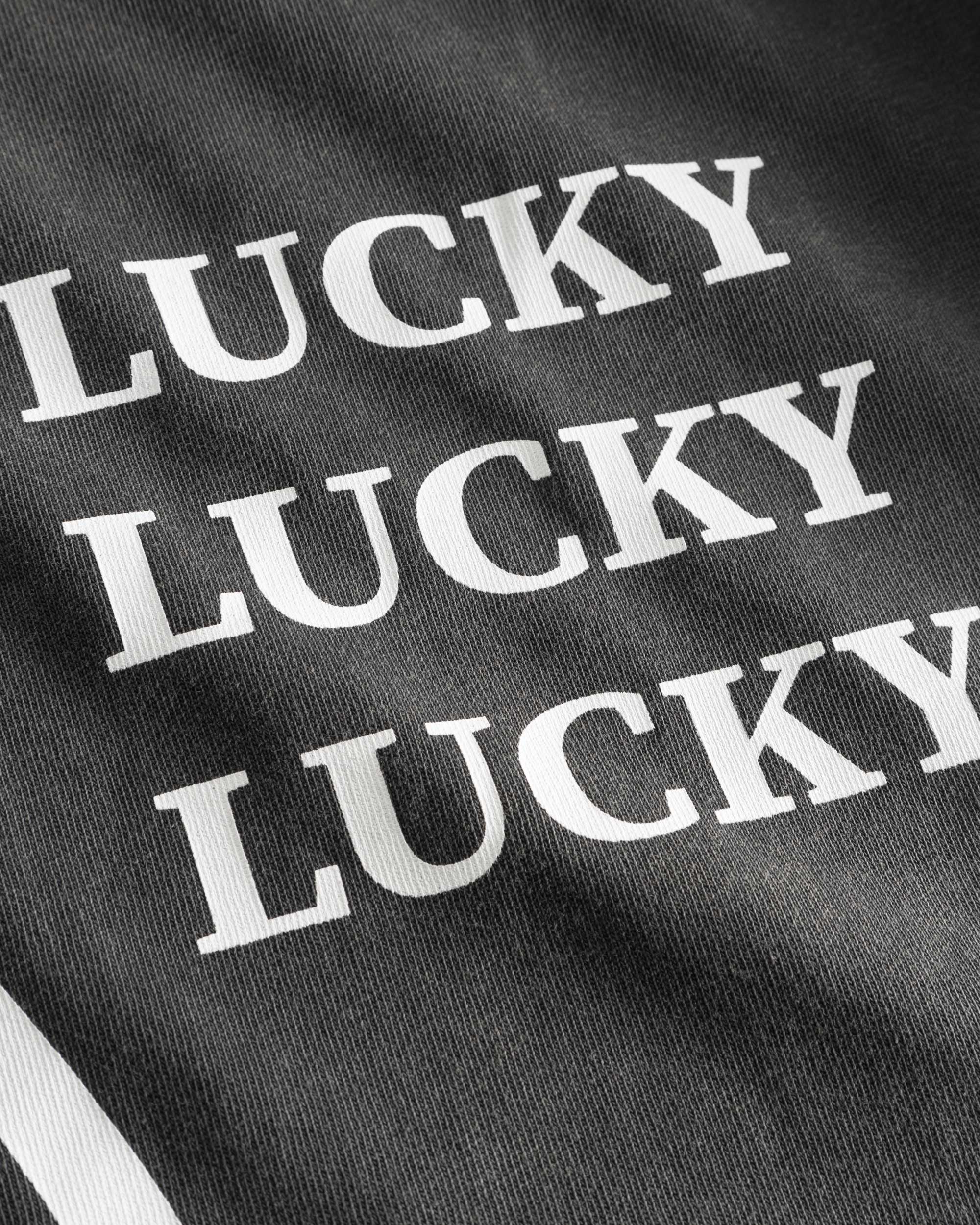 White "Lucky" text print on washed black t-shirt.