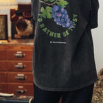 Washed black t-shirt with large back print of grapes and text.