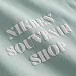 White puffy "Nikben Souvenir Shop" print on grey t-shirt