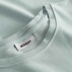 Close-up view of the round neck and stitchings on a grey t-shirt