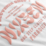 Close up view of orange text print on white t-shirt.